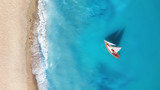 Yacht on the water surface from top view. Turquoise water background from top view. Summer seascape from air. Travel concept and idea