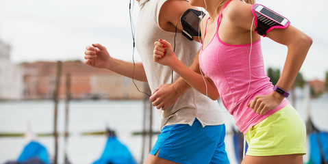 Man and woman running together in city