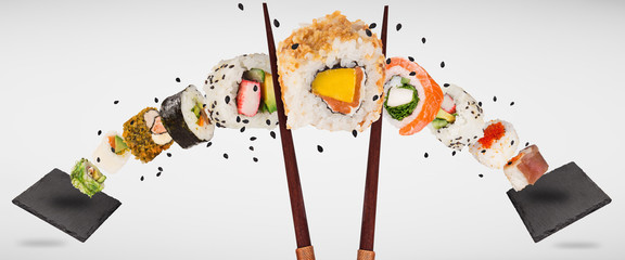 Pieces of delicious japanese sushi frozen in the air.