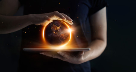 Earth at night was holding in human hands and technology. Earth day. Energy saving concept, Elements of this image furnished by NASA