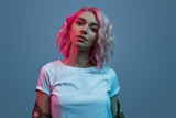 Stylish woman under fuchsia light