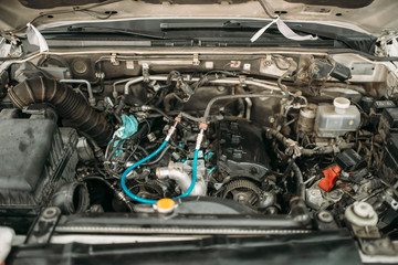 Car with opened hood, closeup view on engine