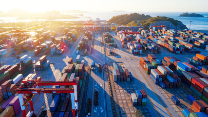 Container ship in export and import business and logistics. Shipping cargo to harbor by crane. Water transport International. Aerial view