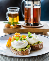 sandwich with avocado and poached eggs