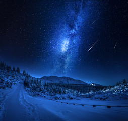 Mountain snowy path in winter with milky way, Tatars