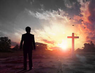 Thanksgiving concept: a businessman standing in front of the cross