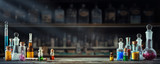 Vintage medications in small bottles on wood desk. Old medical, chemistry and pharmacy history concept background. Retro style.