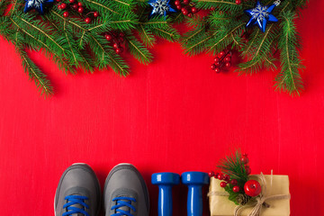 Christmas sport composition dumbbells sneakers branches concept healthy lifestyle