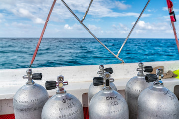 Scuba diving air tanks on the boat, ocean with horizon