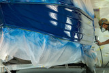 spray gun with paint for painting a boat