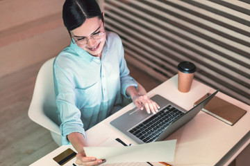 Charming female person checking documents