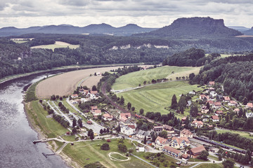 Rathen village by the Elbe River bank an a cloudy day, retro color toned picture, Germany.