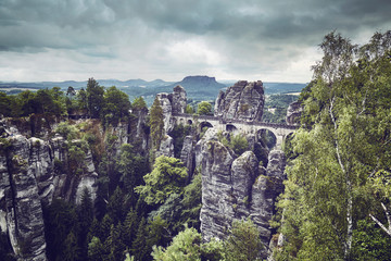 Vintage toned picture of the Bastei Bridge in Saxon Switzerland National Park, Germany.