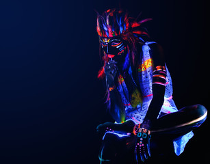 Woman with a neon makeup in ultraviolet light