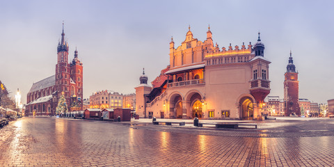 Krakow, Poland, main market square, winter night, St Mary's church and Cloth Hall illuminated