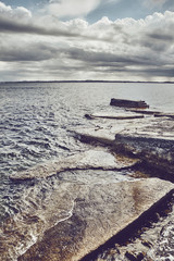 Seascape with stormy clouds, color toned picture.