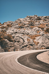 Mountain road curve, travel concept color toned picture.