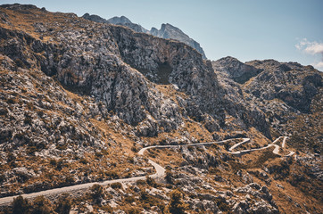 Mountain winding road, travel concept color toned picture.