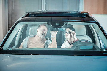 Loving couple feeling excited before traveling by car