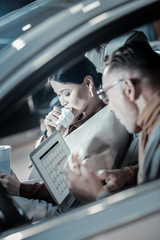 Overloaded businessmen working and eating in their car