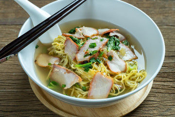 Red pork noodles ,bowl of noodles with vegetables