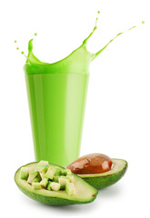 Splash green smoothie or yogurt in glass and avocado