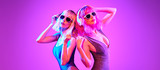 Fashion. Two DJ girl with Dyed Hair in Colorful neon light enjoy music, friends. Party disco 80s 90s vibes. Model woman in fashionable bodysuit, makeup. Creative art banner