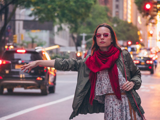 Beautiful girl catching a taxi