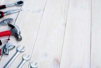 Repair tools on a white wooden background. Jack keys and hammer. Space for text.