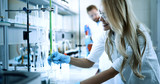Young students of chemistry working in laboratory