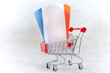 Business concept photo - shopping cart with Flag of France