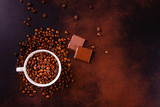 Seeds of fragrant coffee, coffee drink on a dark concrete background. It can be used as a background