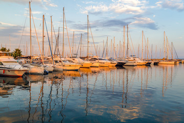 Yachts and boats in the harbor at sunset, reflection, beautiful coastal view, French Riviera. Holidays in France.