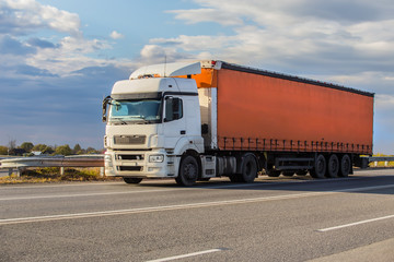 Truck semi-trailer moves along the highway