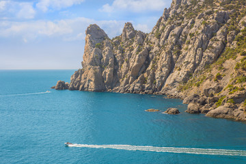 riding motorboats on the sea at a rocky shore