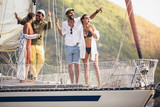 Smiling friends sailing on yacht. Vacation, travel, sea, friendship and people concept