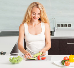 Young woman preparing vegetable salad