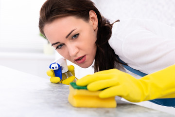 Woman Cleaning Dirty Kitchen Counter