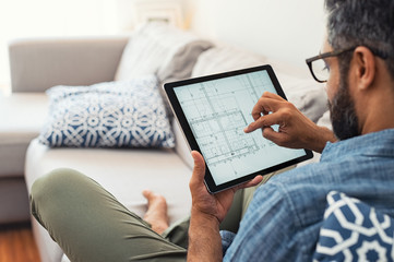 Man working on tablet on house project