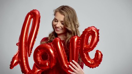 Smiling woman holding word love