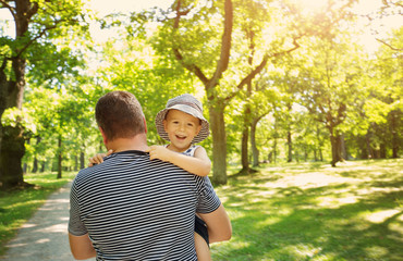 Father playing with son on sunny day in summer