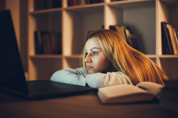 Tired student learning at home. Watching online course.