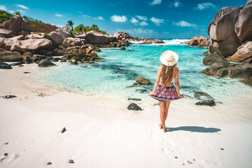 A young girl standing in shallow water on La Digue island, Seychelles