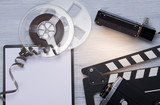 on a light background, film, old video camera, double for shooting and a clean notebook, with space for writing