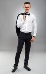 Young businessman on gray