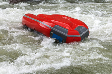 Brave people travel by raffting on a mountain river