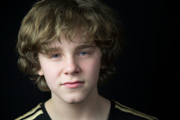 portrait of a teenager on a black background