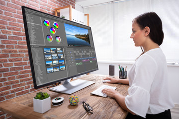 Female Editor Editing Video On Computer