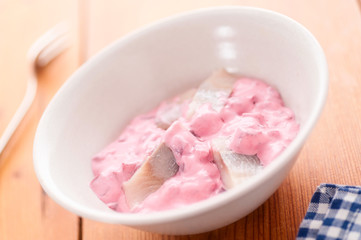 Herring Salad with Beet in bowl selective focus