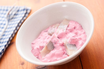 Herring Salad with Beet in bowl selective focus